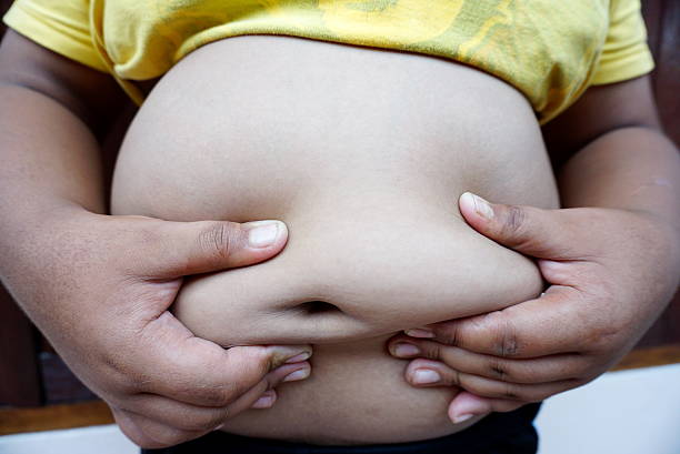 istock fat boy big stomach and belly close up 532568214