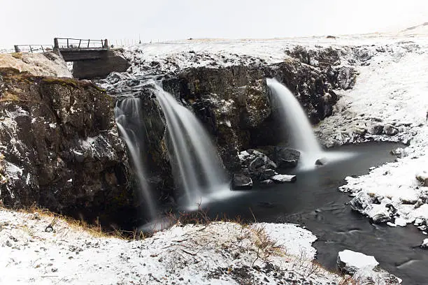 Winter landscape. Waterfalls surrounded by snow.