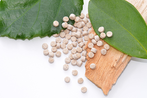 pellets of biopolymer with leafs and wood
