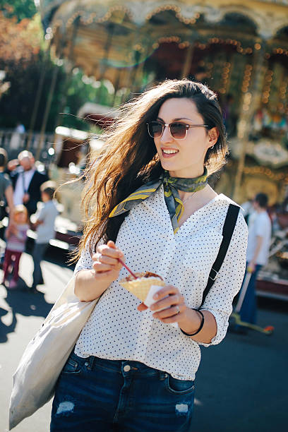 istock Young Parisian woman eating ice cream 532571148