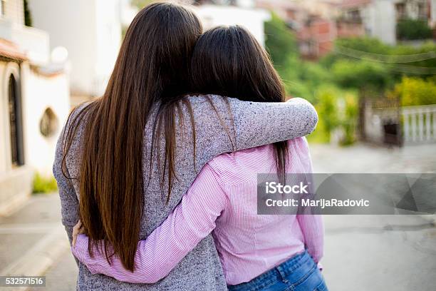 Two Identical Teenage Girlfriends Shot From Back Stock Photo - Download Image Now - Embracing, Rear View, Sister