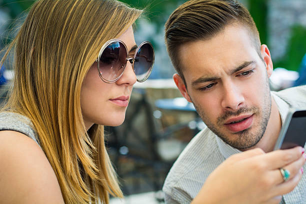 istock Young couple watching in mobile phone 532573256