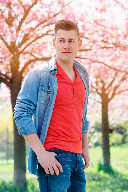 istock portrait of man outdoors with cherry blossom 532573478