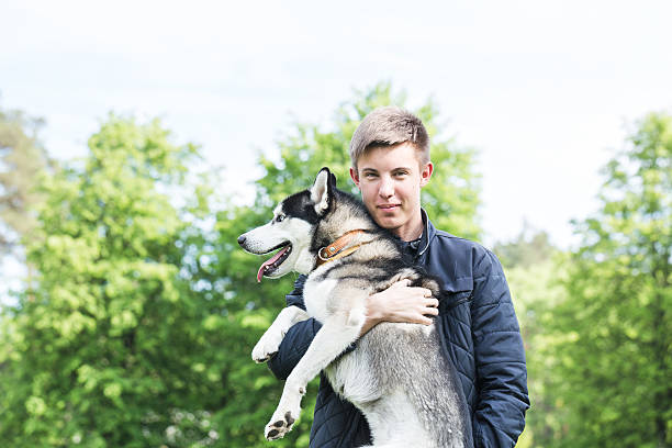istock Owner and Siberian husky on a walk in the park. 532573584