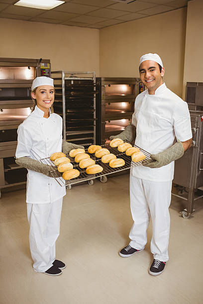 istock Team of bakers holding rolls 532573887