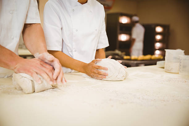 istock Team of bakers kneading dough 532574421
