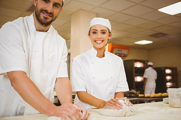istock Team of bakers kneading dough 532574431