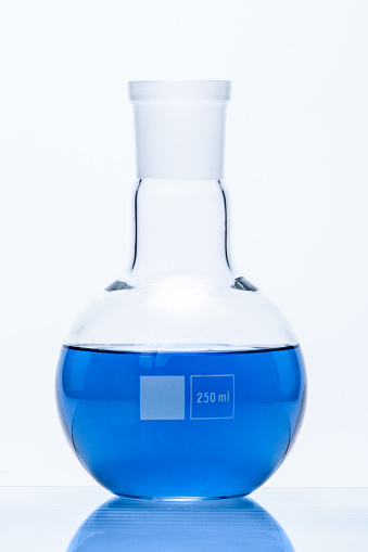 Spherical flat bottomed temperature resistant flask with blue liquid