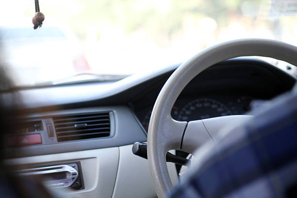 Close-up of hands on a steering wheel