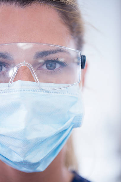 istock Close up of a dentist in mask looking at camera 532576363