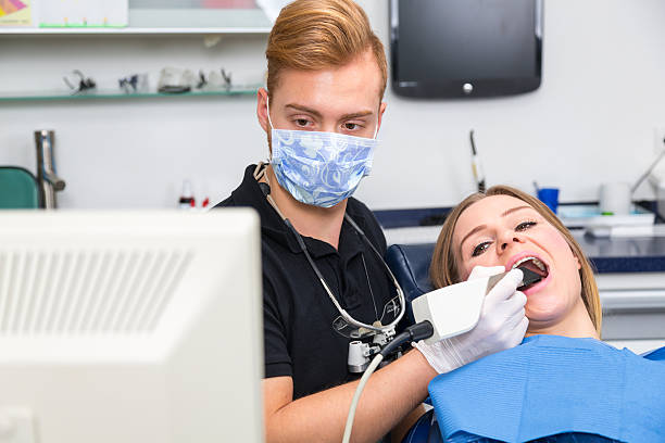 istock Dentist scanning the teeth of patient with CEREC scanner 532576854