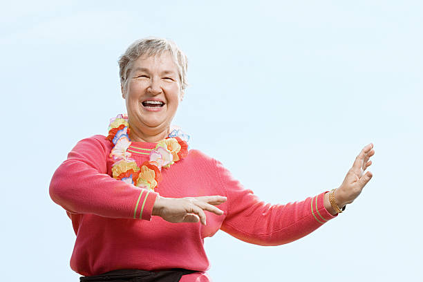 Woman wearing flower garland and dancing Woman wearing flower garland and dancing hula dancing stock pictures, royalty-free photos & images