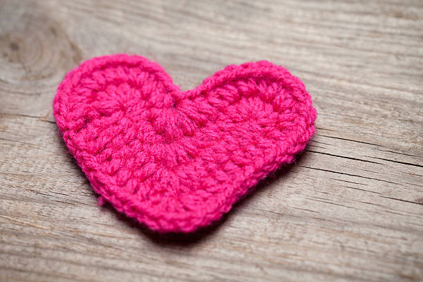istock Crochet heart on wooden table 532579239