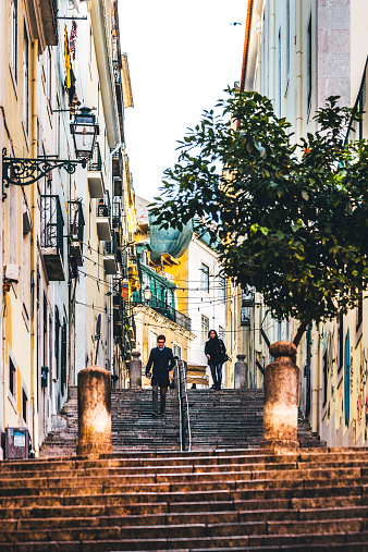 Lisbon, Portugal - December 31, 2014: Streets of Bairro Alto neighbourhood, a few people walking down the stairs.