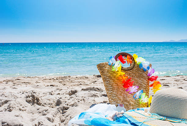 istock straw bag and hat on the beach 532579666