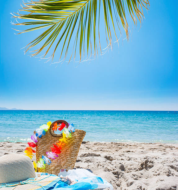 istock straw bag and hat on the beach 532579866