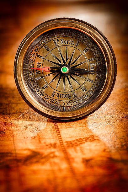 istock Vintage compass lies on an ancient world map. 532580040