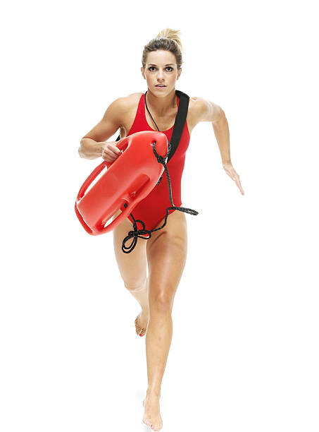istock Female lifeguard with life buoy running 532580483