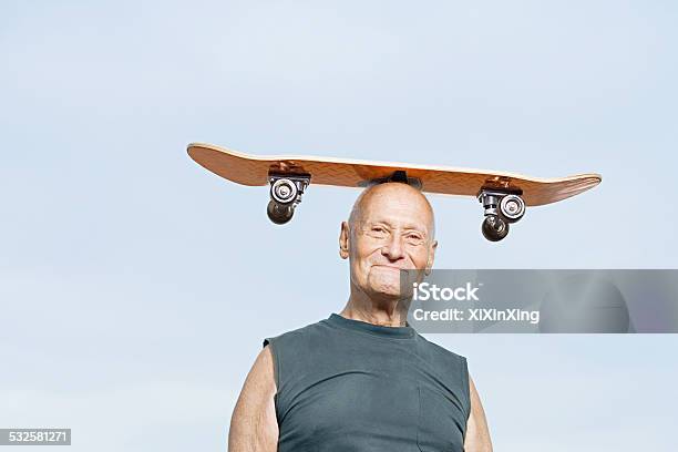 Man With Skateboard On His Head Stock Photo - Download Image Now - Senior Adult, Humor, Skateboarding