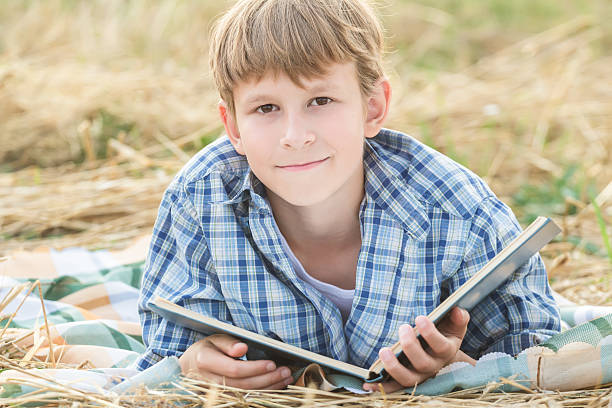 Teenage boy reading big book