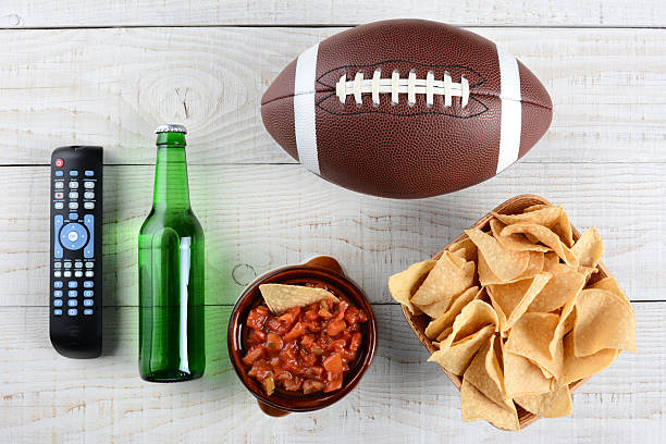 istock TV Remote, Salsa, Beer, Chips and Football 532590149