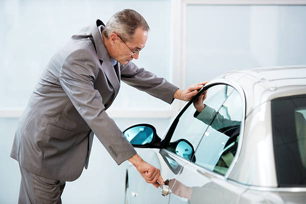 istock Businessman examining new car. 532590347