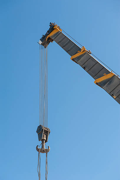 istock Large crane jib against blue sky background 532590475
