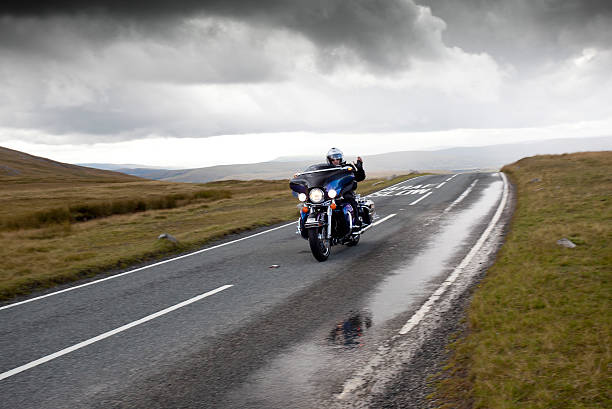 harley davidson motorbike on mountain road stock photo