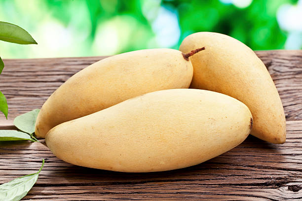 istock Mango fruits on a wooden table. 532593913