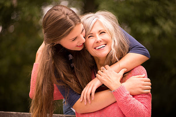 istock Daughter Surprises Mother With a Hug From Behind 532604529