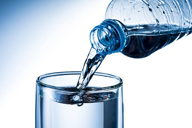 istock Water bottle pouring into glass 532604645