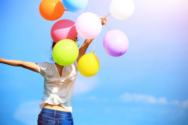 istock young asian woman  with colored balloons 532604713