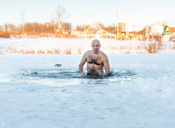 istock Winter swimming. Man in  ice-hole 532605509