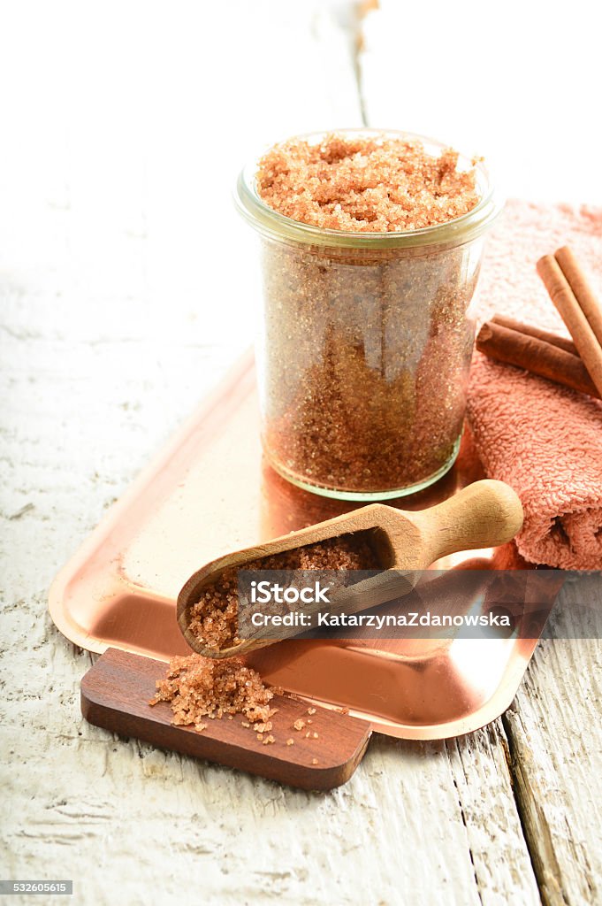 Body scrub - brown sugar with cinnamon. Cinnamon body scrub on a white background 2015 Stock Photo