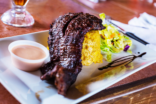 Traditional Puerto Rican Churrasco and Mofongo with salad.