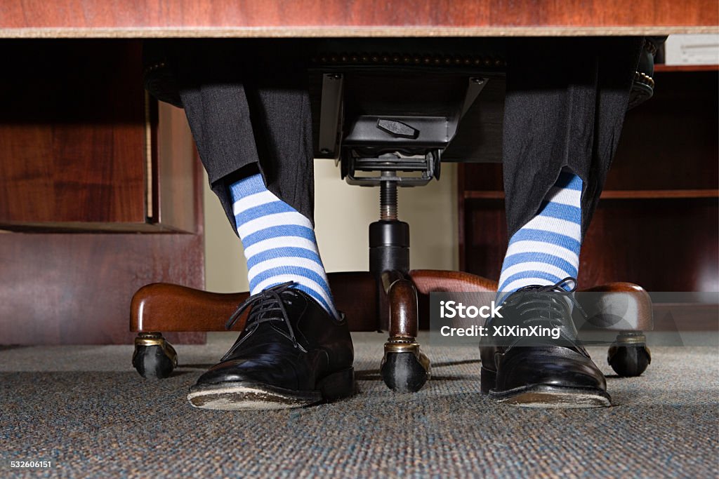 Businessman with striped socks Office Stock Photo