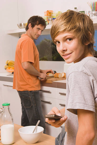istock Father and son in kitchen preparing meal 532609291