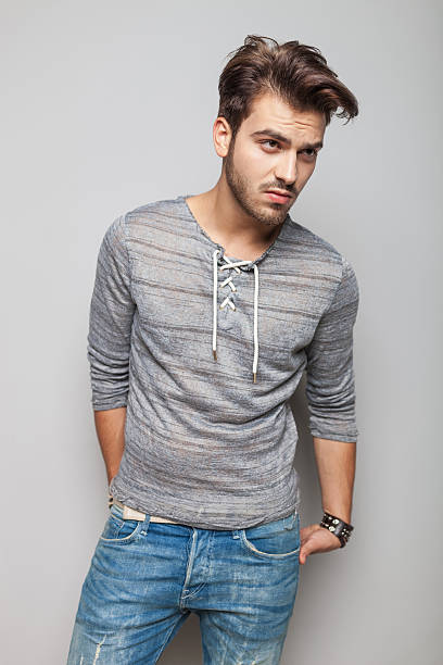 istock fashion man holding his hands in his back pocket 532609431