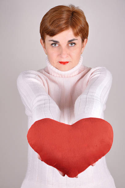 istock Woman holding a plush red heart 532611923
