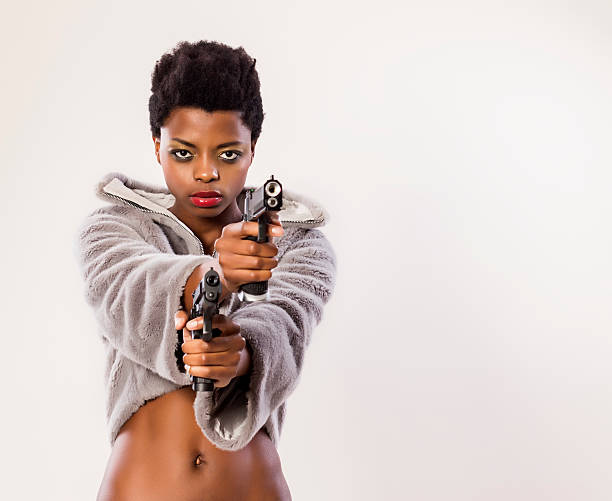 istock Woman with two guns 532624697