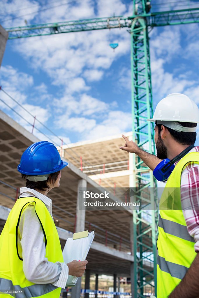 Construction checking routine Construction teamwork checking the site. 2015 Stock Photo