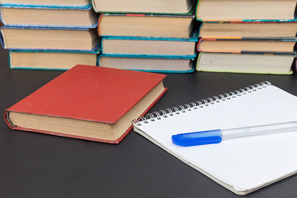 istock notebook on rings, red book  and pen on background book 532627791