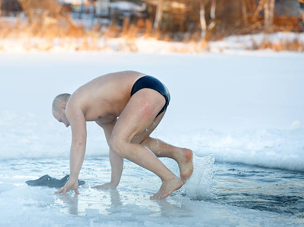 istock Winter swimming. Man to an ice-hole 532641441