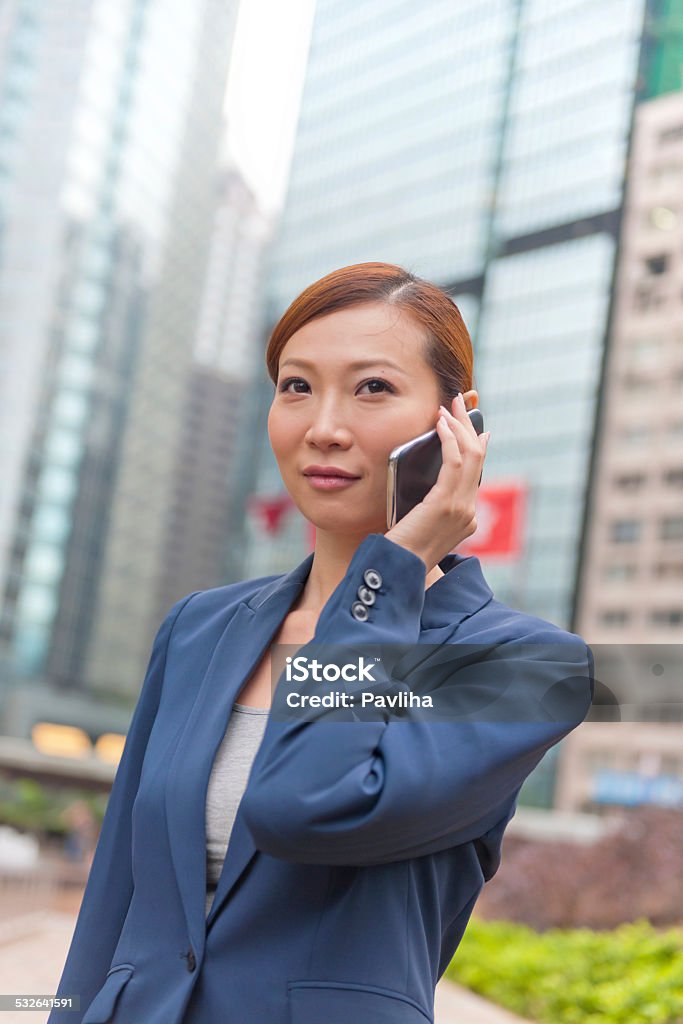 Businesswoman in Hong Kong, China. Businesswoman on her cellphone, Hong Kong, China.Businesswoman on her cellphone, Hong Kong, China. 2000-2009 Stock Photo