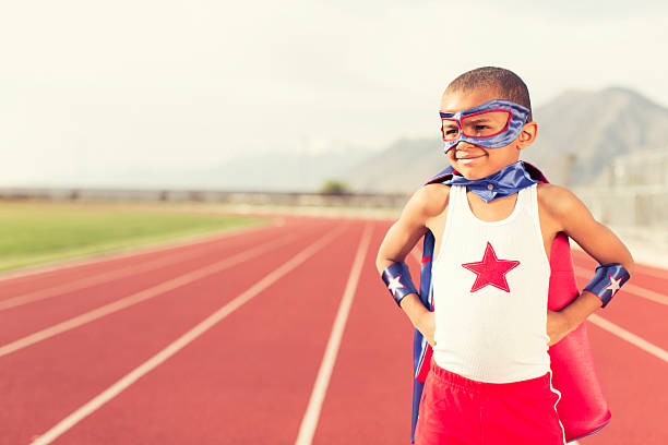 istock Young Boy Dressed as Superhero Stands on Running Track 532641685