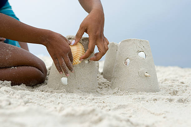 istock Mother and child putting a shell on a sandcastle 532643345