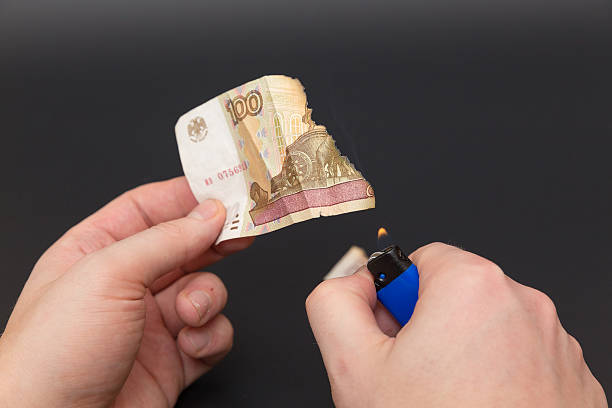 istock part of 100 ruble in fire on black background 532643717