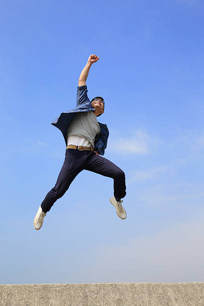 счастливый человек бег и прыжки  - japanese ethnicity college student student asian ethnicity стоковые фото и изображения