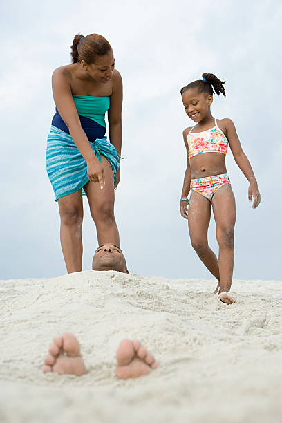 istock Father buried in the sand 532645243