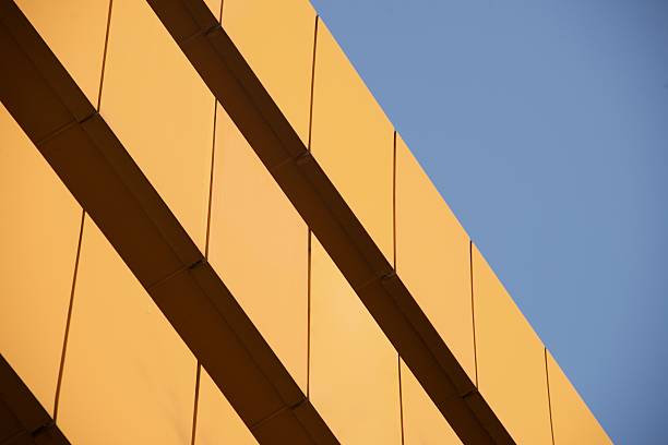 istock Wall of orange building against blue sky 532645463